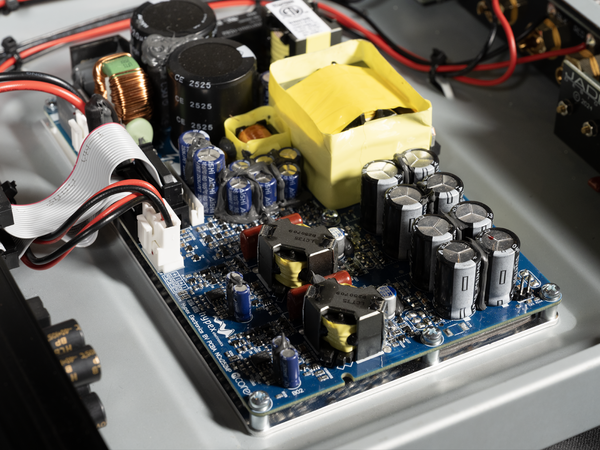 Close-up of an electronic circuit board with various components on a gray background