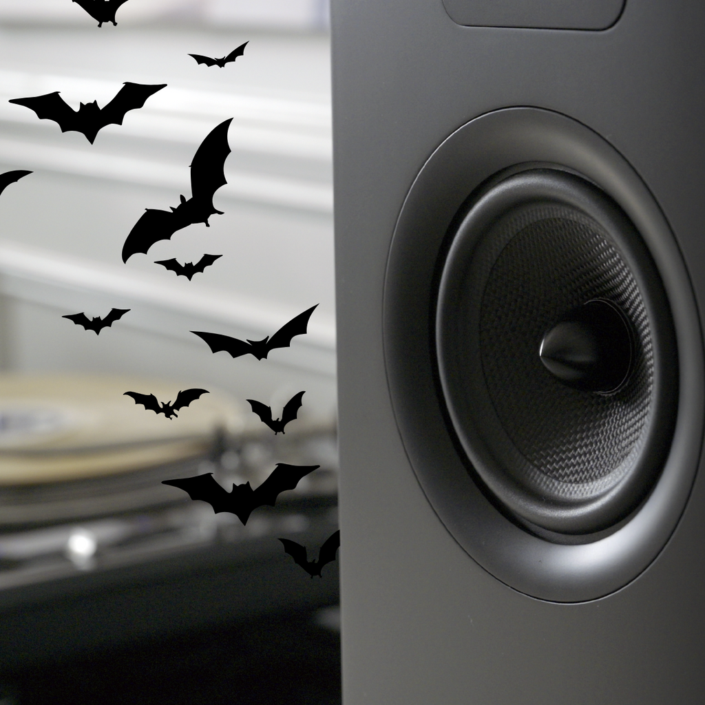 Close-up of a speaker with decorative bats on a blurred background