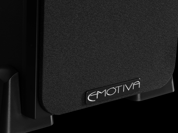 closeup photo of the metal Emotiva badge located at the bottom of every Airmotiv X loudspeaker grill